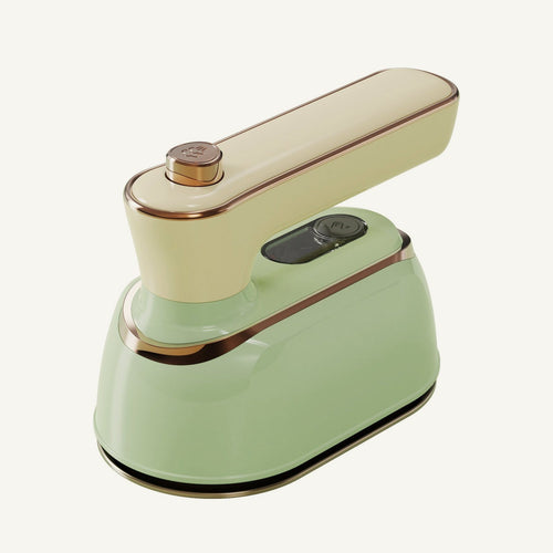 Lisvelle Mini Steam Iron in Sage: pale green body, cream handle, fine gold trim